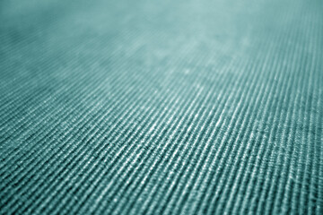 Cyan color textile pattern close-up with blur effect.