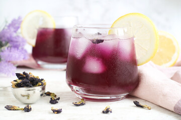 Fresh and colorful butterfly pea flower with lemon juice , healthy herbal fresh drink with many health benefit on a wooden table