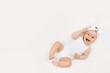 © Any Grant - smiling baby on a white bed at home, the concept of a happy, healthy baby, a place for text