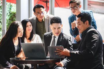 Wall Mural - From above of group of diverse colleagues in formal clothing discussing business ideas while gathering at table in modern office and working together