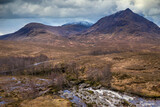 Fototapeta Tęcza - Flying drone epic landscape image of mountains rivers and valleys in Glencoe in Scottish Highlands on a Winter day