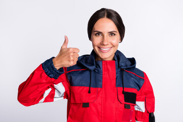 Sticker - Photo of cheerful shiny young urgency woman wear red jacket smiling showing thumb up isolated white color background