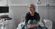 © TommyStockProject - Young woman with cancer sitting alone on hospital bed during chemotherapy