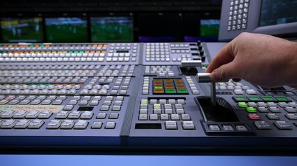 Wall Mural - Hand adjusting on switcher buttons in studio TV station, Television Broadcast.