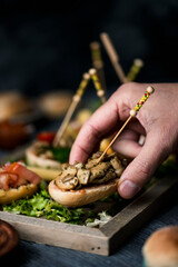 Poster - man taking a vegan spanish pincho from a tray