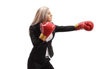 Poster - Businesswoman in a suit with boxing gloves punching