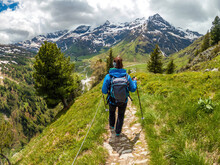 A Young Female Hiker Does Trail Hiking In The Mountains Of Gastein In Austria.