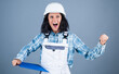 © be free - smiling female architect in safety hard hat, blueprint