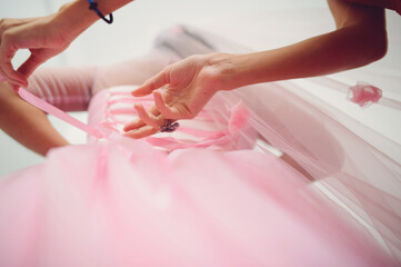 Wall Mural - bridesmaid helping bride with corset