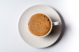 Fototapeta Boho - Flat lay black coffee with foam in a white cup isolated on white background.