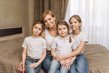 the concept of maternal love and care. portrait of a young mother with three children, daughters. ha