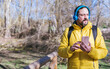 © Diego - hipster man with a beard listening to music with headphones and cell phone while walking on a sunny day.