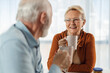 © Goran - Happy senior couple having their morning coffee in dining room