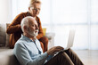 © Goran - Senior couple surfing the Internet on their laptop at home