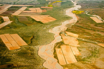 Canvas Print - Aerial view of river winding through colorful farmland, Uyuni, Potosi Department, Bolivia