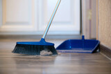 Fototapeta Pokój dzieciecy - Broom brush and dustpan on the floor. Home cleaning.