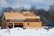 winter construction of a plywood house roof framework
