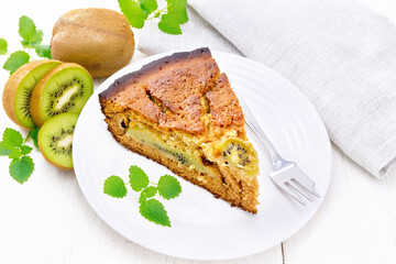 Poster - Pie with kiwi in plate on wooden board