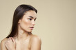 © SHOTPRIME STUDIO - Woman with bared shoulders dark hair clean skin makeup beige background