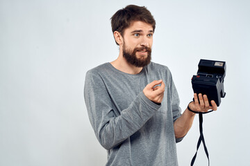 Canvas Print - Male photographer holding a professional camera tasty technology hobby