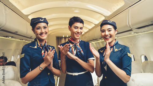 Cabin crew clapping hands in airplane . Airline transportation and tourism concept.