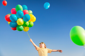 Wall Mural - Happy child playing outdoors in spring field