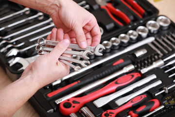 Wall Mural - tool store. closeup of male hand holding wrenches. auto repair kit in toolbox. repairman instruments