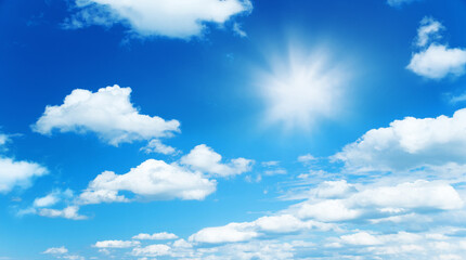 Wall Mural - sunny background, blue sky with white clouds and sun as summer or spring natural background.