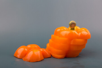 orange color bell pepper slices isolated on the grey background.