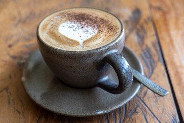 cappuccino on brown wooden table