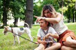 © iordani - young pretty caucasian mother walking with little cute daughter and dog fox terrier, lifestyle people concept
