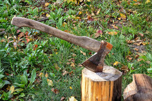 Old Rusty Axe In A Wooden Stump