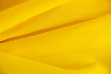 Wall Mural - yellow silk crumpled fabric as background close-up