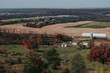 Scenic view of cows grazing on beautiful rural farm land in Eastern Iowa near Balltown during the fall. Landscape farming fields, barns and homes in the Mississippi River Valley with autumn colors. 