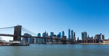 Fototapeta  - View of Brooklyn Bridge and Manhattan skyline WTC Freedom Tower from Dumbo, Brooklyn. Brooklyn Bridge is one of the oldest suspension bridges in the USA