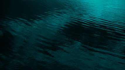 Wall Mural - dark blue green abstract background. reflection of light on a smooth surface of water with small wav