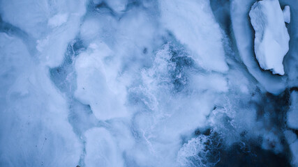 blue white snowy river in winter aerial