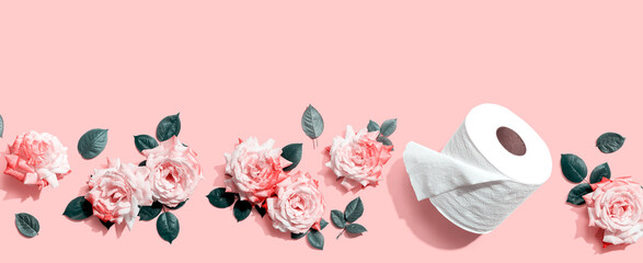 Toilet paper with pink roses overhead view - flat lay