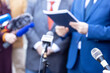 © wellphoto - News conference, journalists with microphones interviewing politician or business person during media event