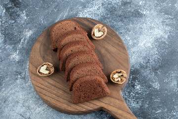 Wall Mural - A wooden cutting board with slices of bread and walnuts