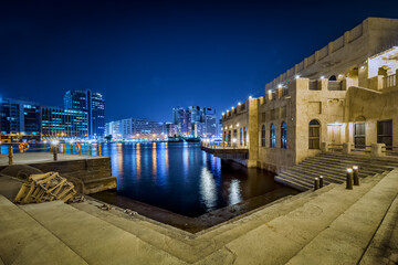 Wall Mural - Dubai, UAE, 23 November 2020: Al Seef Dubai Creek at night. Public water transportation connecting several districts like Business Bay and Marina.