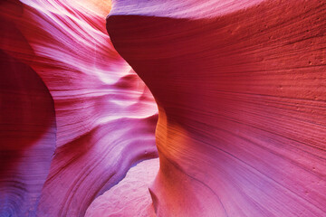 Beautiful red and orange sandstone wall with warm subtle light glow inside Antelope Canyon, Arizona, America