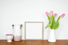 Mock Up Square Wood Frame With Home Decor, Plant And Spring Flowers. Wooden Shelf Against A White Wall. Copy Space.