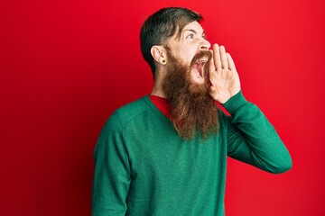 Sticker - Redhead man with long beard wearing casual clothes shouting and screaming loud to side with hand on mouth. communication concept.