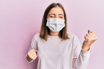 Sticker - Young beautiful woman wearing medical mask celebrating surprised and amazed for success with arms raised and eyes closed