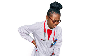 Young african american woman wearing doctor uniform and stethoscope suffering of backache, touching back with hand, muscular pain