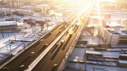 Wall Mural - Top view of the freeway through cityscape at sunny sunset