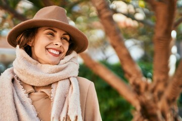 Young hispanic woman wearing elegant style standing at the city.