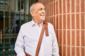 Wall Mural - senior businessman smiling happy walking at the city.