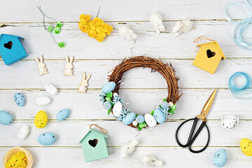 Handmade diy home interior decoration wreath with easter eggs in blue and yellow colors